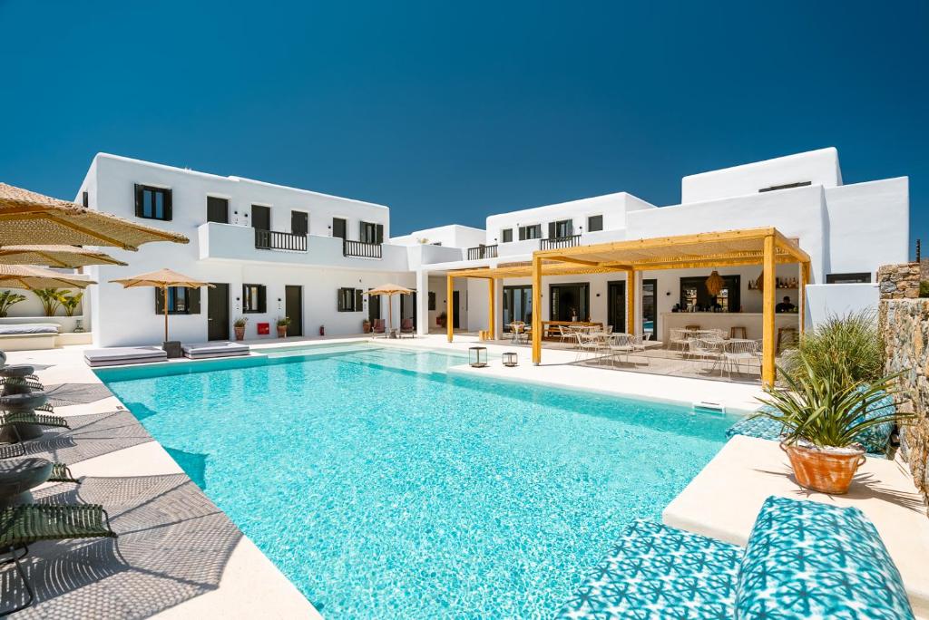 Koukoumi Boutique Hotel in Mykonos, Greece with white buildings and turquoise pool